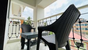 a balcony with a table and chairs on a balcony at Studio flats in Candolim in Candolim