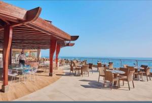 a patio with tables and chairs and the ocean at Hotel Sea Palace Ltd in Cox's Bazar