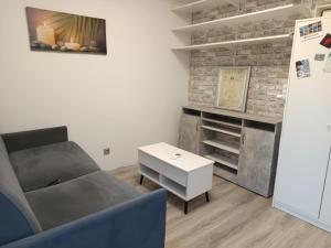 a living room with a couch and a table at Appartement mignon in Gardanne