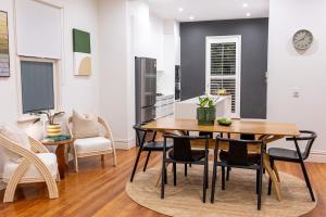 a dining room with a table and chairs at Designer Darlinghurst Townhouse in Sydney