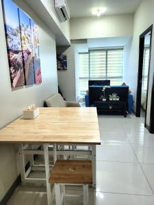 a living room with a table and a couch at BGC Uptown Park Suites Tower 1 - 2 Bedroom and 2 Bath Condo in Manila +15 photos