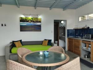 a living room with a table and chairs and a couch at Altos de Guarame in Flandes +7 photos