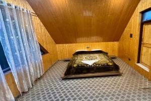 a bathroom with a bed in a room with curtains at ROYALE PEAKS villa sonamarg Rd 