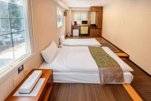 Postel nebo postele na pokoji v ubytování Hakuba Sun Valley Hotel Annex - Vacation STAY 90351v