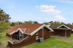 a house with a red roof and a yard at Modern Holiday Home With 200M To Beach in Store Fuglede