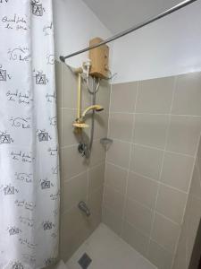 a bathroom with a shower with a shower curtain at A venue Residences 1801 in Manila +14 photos