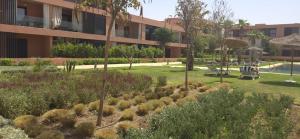 a garden in front of a building with plants at Dar Sofia Noria in Marrakech