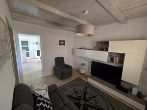 a living room with a couch and a chair at Nereide in Cavallino-Treporti