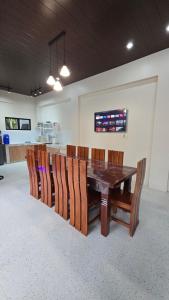 a dining room with a wooden table and chairs at Casa Zavia in Sampong