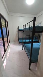 two bunk beds in a room with a window at Casa Zavia in Sampong +7 photos