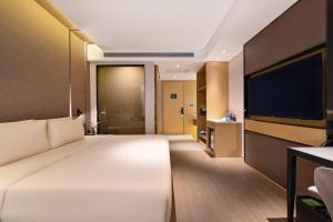 Postel nebo postele na pokoji v ubytování Atour Hotel Dalian Hi-tech Zone