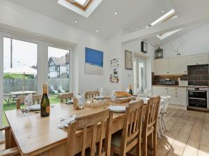 a kitchen and dining room with a wooden table and chairs at Stourcliffe House in Bournemouth