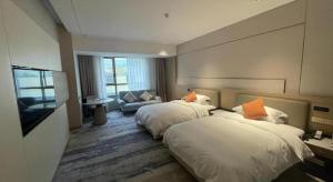 Postelja oz. postelje v sobi nastanitve Zhangjiagang Guomao Hotel