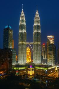 a view of the petronas twin towers at night at Cormar Suites Kuala Lumpur in Kuala Lumpur