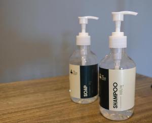 two bottles of soap sitting on a wooden table at The Loom Rangsit in Ban Lam Phak Kut +34 photos