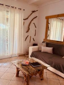 a living room with a couch and a coffee table at Isola Sarda Appart NICE in Murta Maria