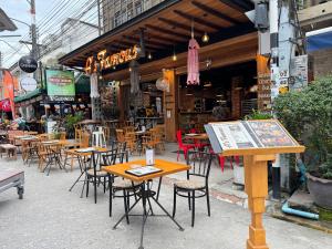 a group of tables and chairs in front of a restaurant at Buakao Inn in Thong Sala