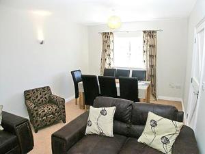 a living room with a couch and a dining room at The Farmhouse in Cromer