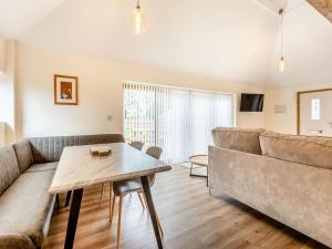 a living room with a couch and a table at Tawny Acre Barn - Uk38614 in Wisbech