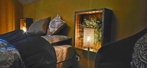a room with two beds and a mirror on the wall at Chez Sam et Brice in Saint-Georges-Buttavent