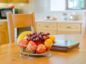 a bowl of fruit sitting on a table at Mulberry Cottage in North Wootton +15 photos