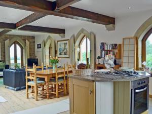 a kitchen and dining room with a table and a stove at The Water Castle in Wall Houses