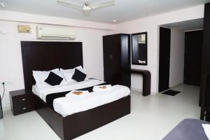 a bedroom with a large bed in a room at Erica Hotel International in Perintalmanna