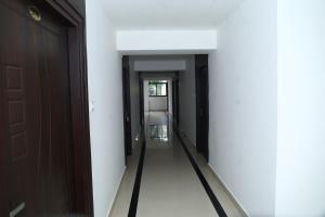 a corridor of a room with two doors at Erica Hotel International in Perintalmanna +35 photos
