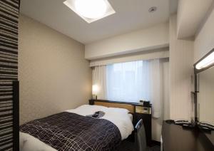 Rúm í herbergi á APA Hotel Kanda Ekimae