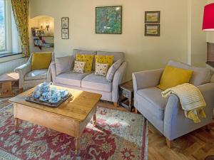 a living room with two couches and a coffee table at Ashby Cottage in Long Compton