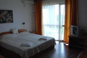 Postel nebo postele na pokoji v ubytování Condo Hotel Valentina