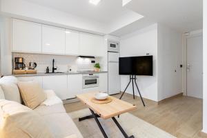 a living room with a couch and a table at Arena One Studio in Fuengirola +9 photos