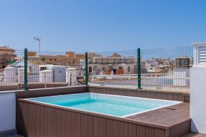 a hot tub on the balcony of a building at Arena One Studio in Fuengirola