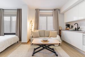a living room with a couch and a table at Arena One Studio in Fuengirola