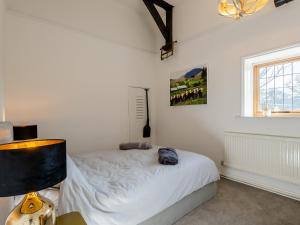 a bedroom with a bed and a window at The Barn in Hunstanton