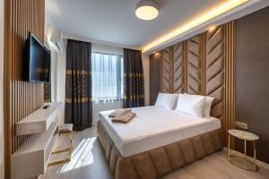 En eller flere senge i et værelse på Santa Maria Luxury Suits