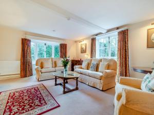 a living room with two couches and a table at The Farmhouse - Uk45894 in Banham