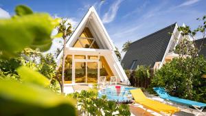 a frame house with a pool in the yard at Oaga Art Resort Maldives - Greatest All Inclusive Plan with Free Speedboat Round-trip in North Male Atoll