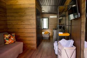 a small room with a bed and a room with wooden walls at Albatross Family Nest Breeze Bungalow in Varna City