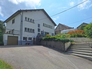 a large white house with stairs and a driveway at L'Aubier in Saint-Maur
