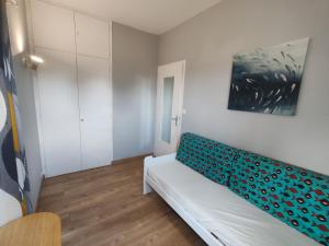 a living room with a couch and a painting on the wall at L'Aubier in Saint-Maur +35 photos
