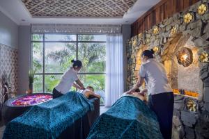 a group of people in a room with beds at Sacred Valley by GenuineHost in Tegalalang