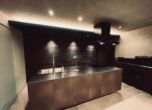 a kitchen with a counter with a sink in it at AWAJI OCEAN BASE east coast in Awaji +66 photos