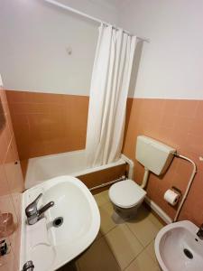 a bathroom with a white sink and a toilet at Residencial Pimenta ,Portimao,Algarve in Portimão