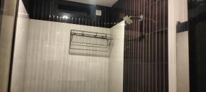 a shower with a shower head in a bathroom at Hotel Vishal - Near Surat Railway Station in Surat +14 photos