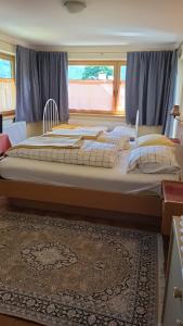 a large bed in a room with a window at Ferienwohnung Haus Julia in Mariapfarr