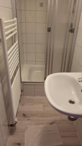 a white bathroom with a sink and a shower at Ferienwohnung Haus Julia in Mariapfarr +50 photos
