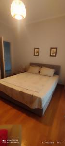 a large bed in a bedroom with a light at Alice House 1 in Amarynthos +43 photos
