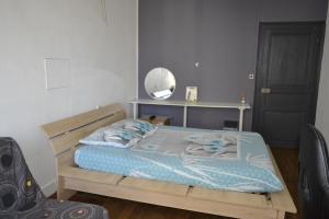 a bedroom with a wooden bed and a mirror at Chambre d'hôte avec piscine partagé à disposition in Chef-Boutonne