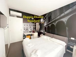 a bedroom with a white bed and a sign on the wall at DiMoras house Verona in Verona +36 photos